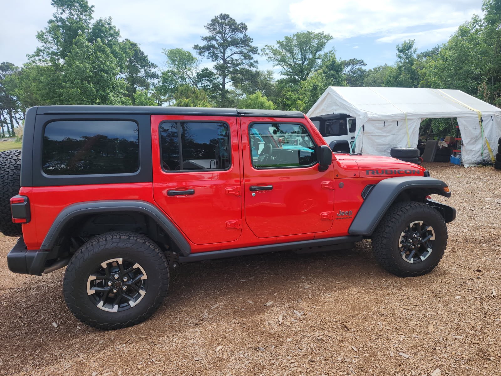 Red Jeep Wrangler Rubicon 4x4 rental at an Outer Banks campsite